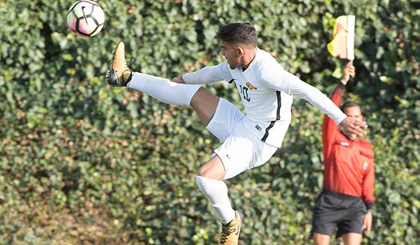 Student Soccer player kicking the ball